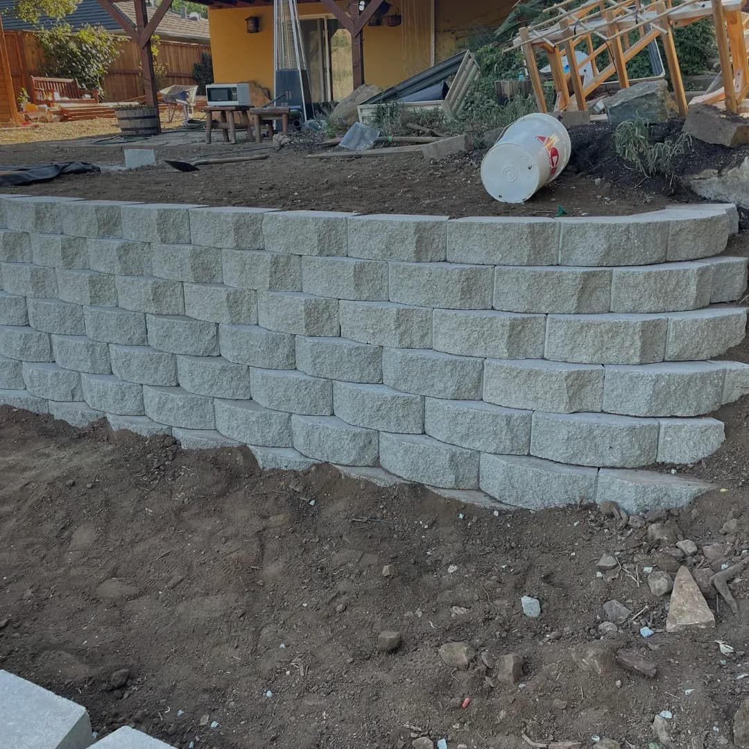 Natural stone retaining wall installation by TP Pavers in California